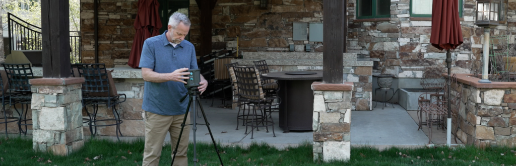 Home Inspector sets up mold testing equipment tools outside.
